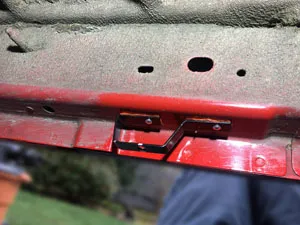 Custom exhaust hanger riveted in place