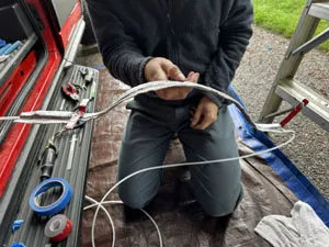 Custom support and insulation for fuel line above exhaust shield